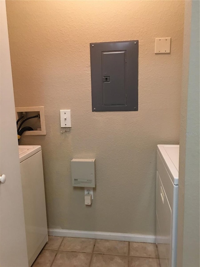 clothes washing area with electric panel, tile patterned flooring, and washing machine and dryer