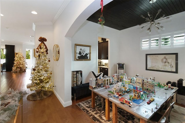 dining space with dark hardwood / wood-style flooring and crown molding