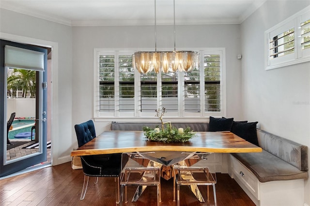 dining room with crown molding, a healthy amount of sunlight, dark hardwood / wood-style flooring, and breakfast area