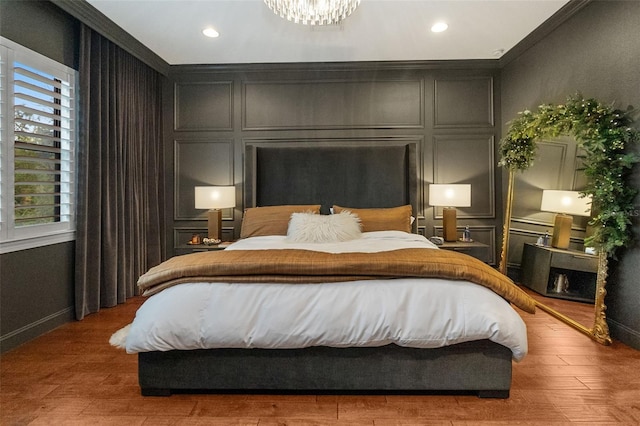 bedroom with wood-type flooring and a chandelier