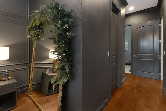 hallway featuring dark wood-type flooring and ornamental molding