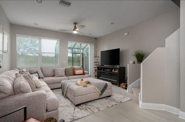 living room with ceiling fan and light hardwood / wood-style floors