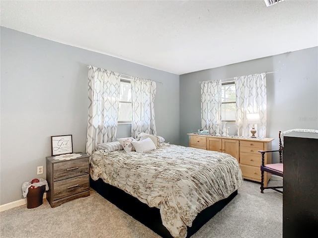 bedroom featuring light carpet