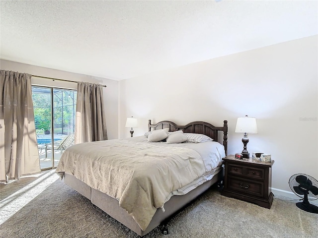 carpeted bedroom with access to exterior and a textured ceiling