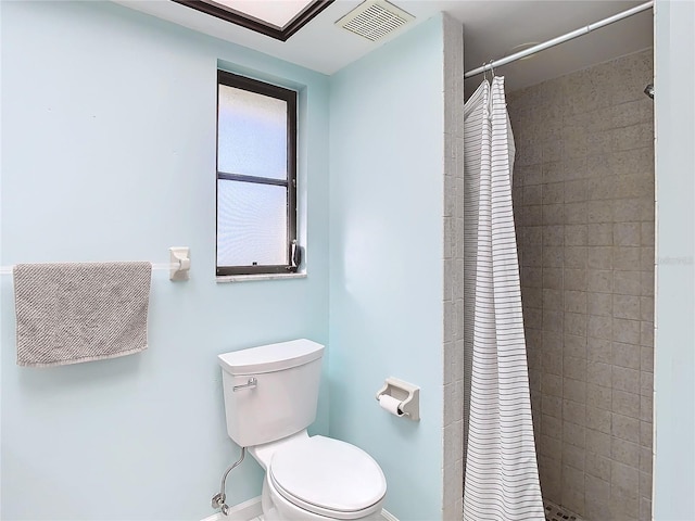 bathroom with a shower with curtain and toilet