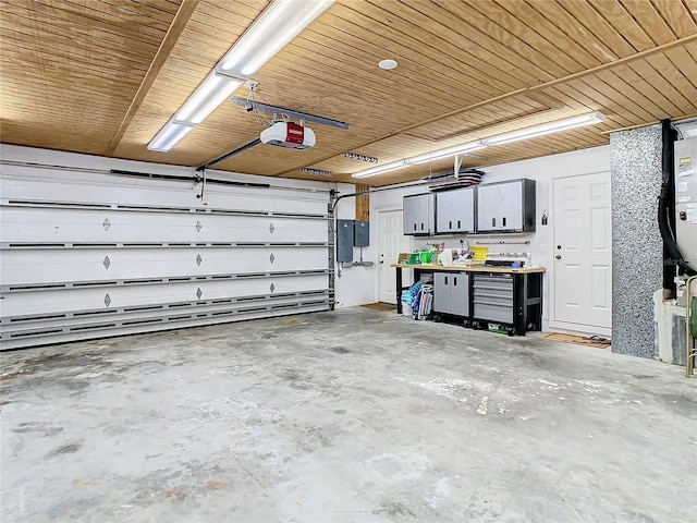 garage with a workshop area, electric panel, and a garage door opener