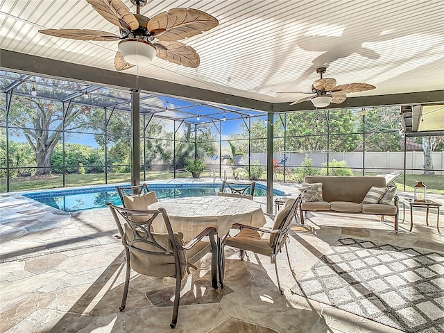 sunroom featuring ceiling fan and a swimming pool