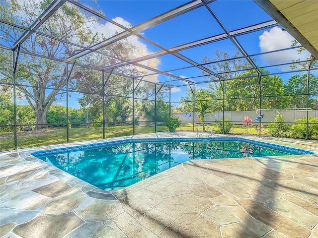 view of swimming pool featuring a lanai and a patio area