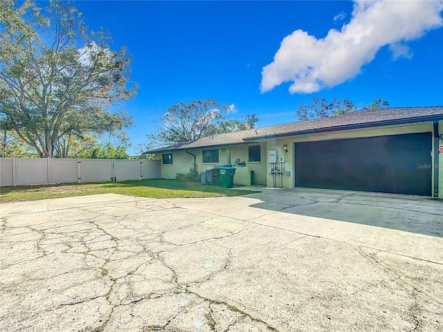 ranch-style home with a front yard and a garage