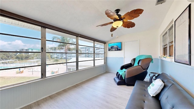 sunroom / solarium featuring ceiling fan and vaulted ceiling