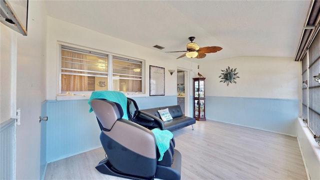 sitting room with light wood-type flooring, ceiling fan, and lofted ceiling