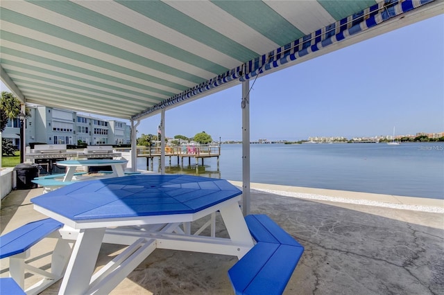 exterior space featuring a water view and a patio area