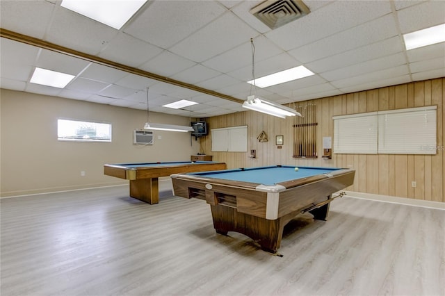 playroom with a wall mounted air conditioner, a drop ceiling, wooden walls, pool table, and light hardwood / wood-style floors