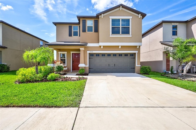 view of front of home with a garage, concrete driveway, a front yard, and stucco siding