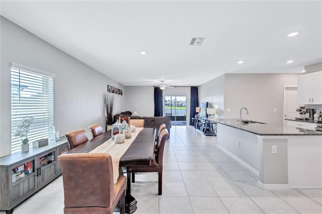 dining area with ceiling fan and sink