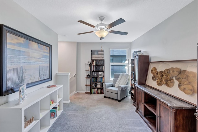 sitting room with light carpet and ceiling fan