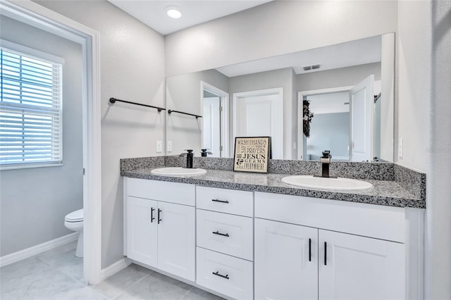 bathroom with tile patterned floors, vanity, and toilet