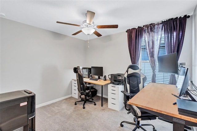 carpeted office space with ceiling fan