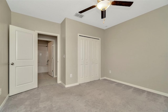 unfurnished bedroom featuring baseboards, carpet, visible vents, and a closet