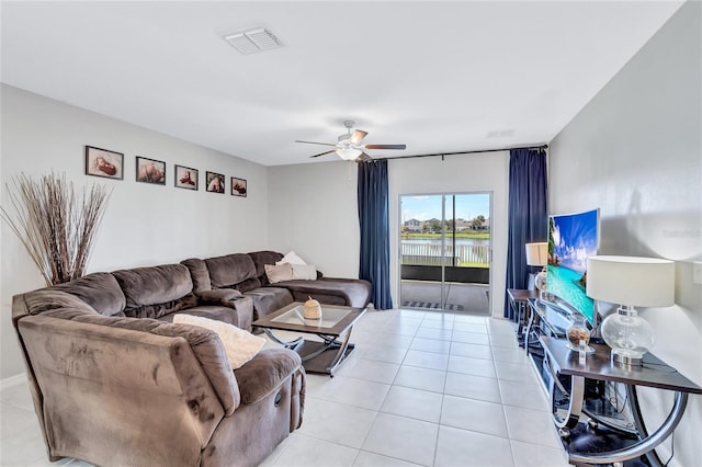 living area featuring light tile patterned floors, ceiling fan, and visible vents