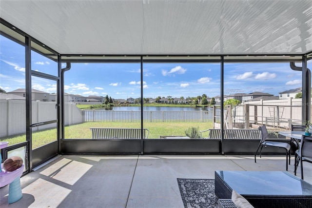 unfurnished sunroom featuring a water view