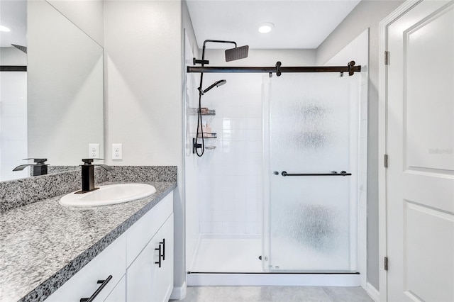 full bath with a shower stall and vanity