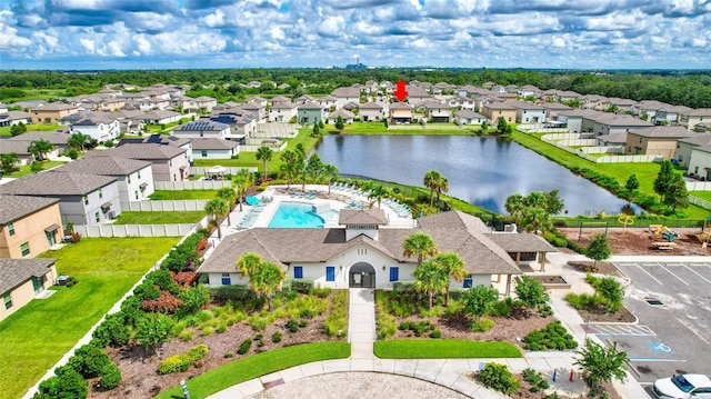 drone / aerial view featuring a water view and a residential view