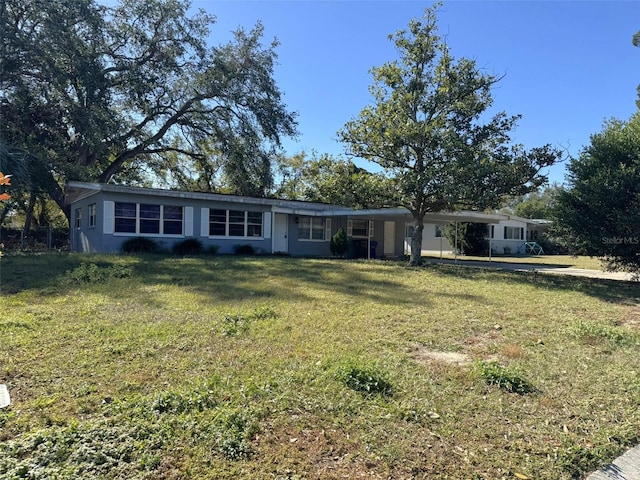 ranch-style home featuring a front yard