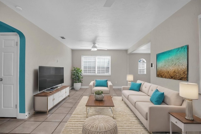 living room featuring light tile patterned floors and ceiling fan