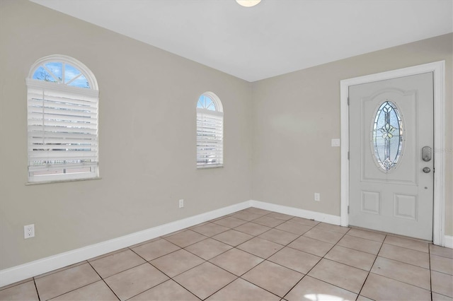 entryway featuring light tile patterned flooring and a wealth of natural light