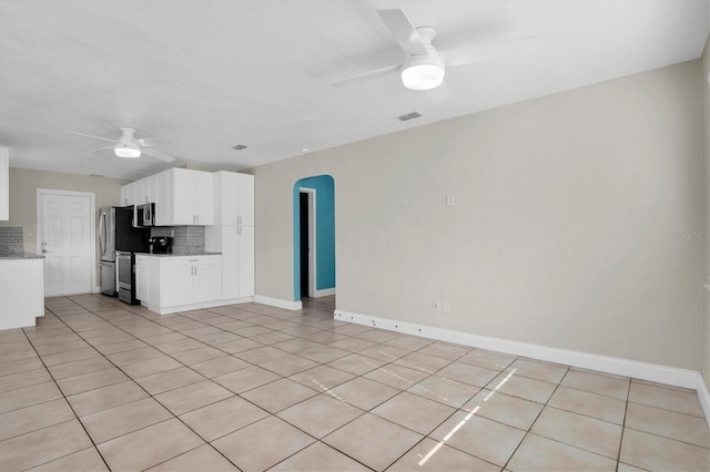 kitchen featuring tasteful backsplash, ceiling fan, white cabinets, and light tile patterned floors