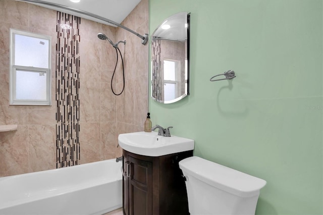 full bathroom featuring vanity, toilet, and tiled shower / bath combo