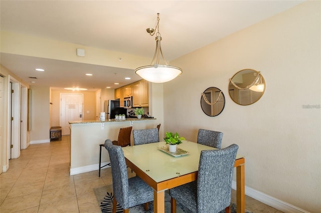 dining space featuring light tile patterned floors