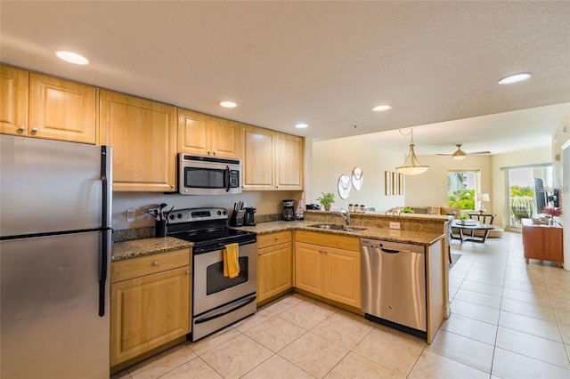 11605 Gulf Blvd Unit 307, Saint Petersburg, FL 33706 - kitchen with appliances with stainless steel finishes, a peninsula, stone counters, open floor plan, and recessed lighting
