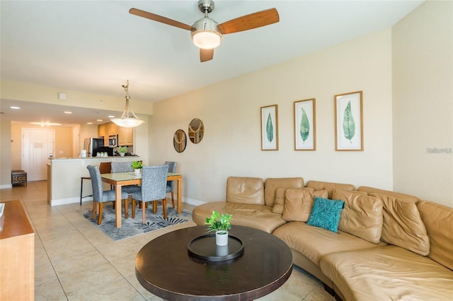 living room featuring light tile patterned floors and ceiling fan