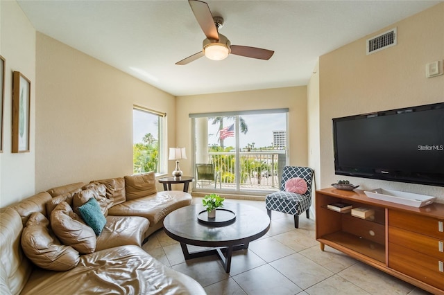 living room featuring ceiling fan and light tile patterned floors