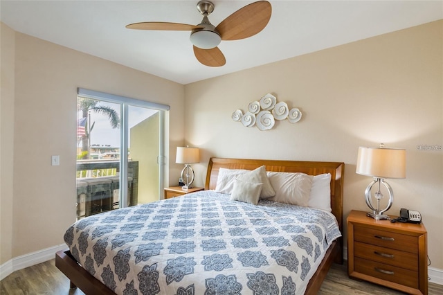 11605 Gulf Blvd Unit 307, Saint Petersburg, FL 33706 - bedroom with wood finished floors, access to exterior, and a ceiling fan