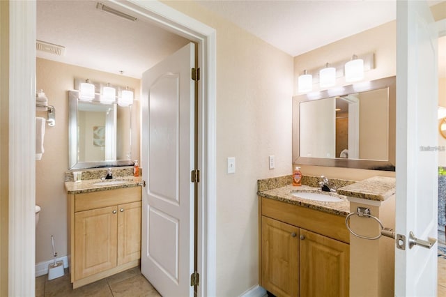 bathroom featuring tile patterned floors and vanity