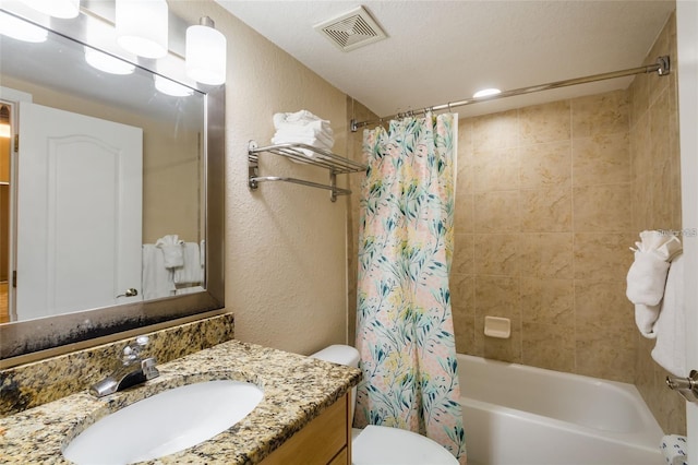 11605 Gulf Blvd Unit 307, Saint Petersburg, FL 33706 - full bath featuring vanity, a textured wall, and shower / tub combo with curtain