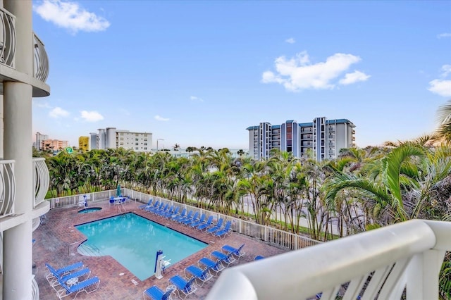 community pool with fence and a patio