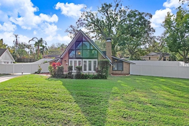 rear view of house featuring a lawn