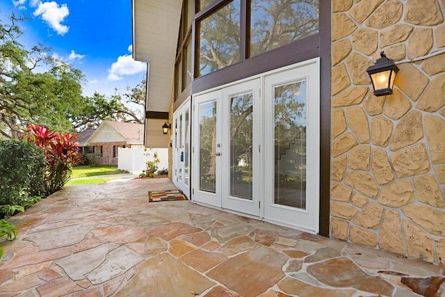 property entrance featuring french doors and a patio area