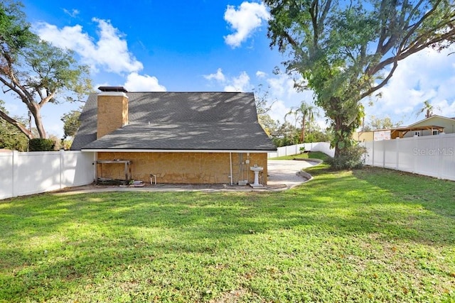 back of house featuring a yard