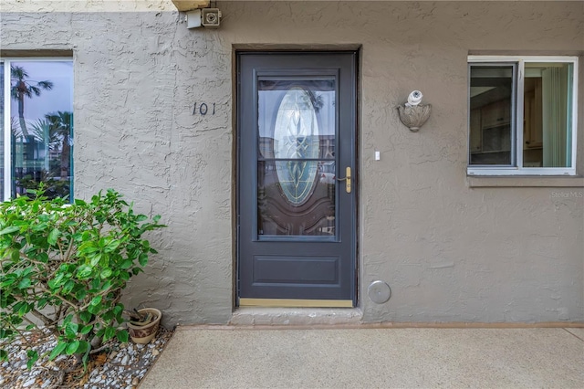 entrance to property with stucco siding