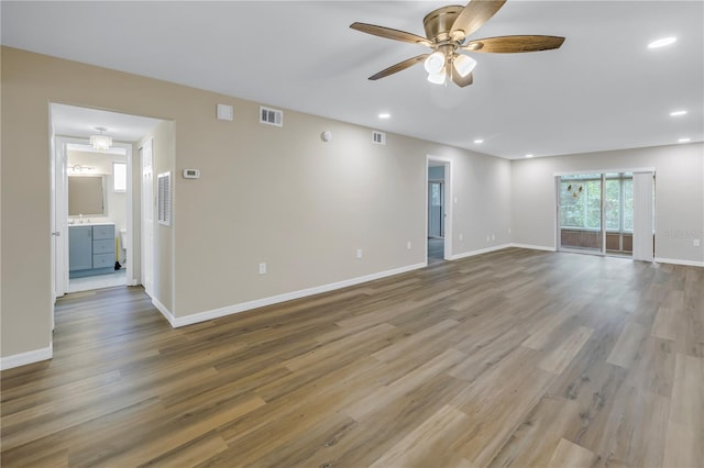 spare room featuring visible vents, baseboards, and wood finished floors