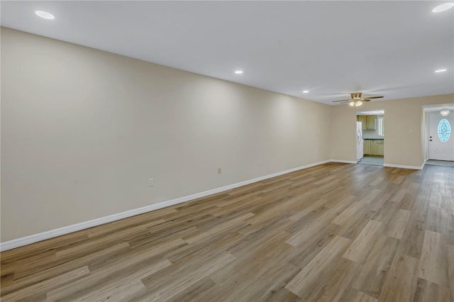 unfurnished living room featuring light wood-style flooring, baseboards, ceiling fan, and recessed lighting