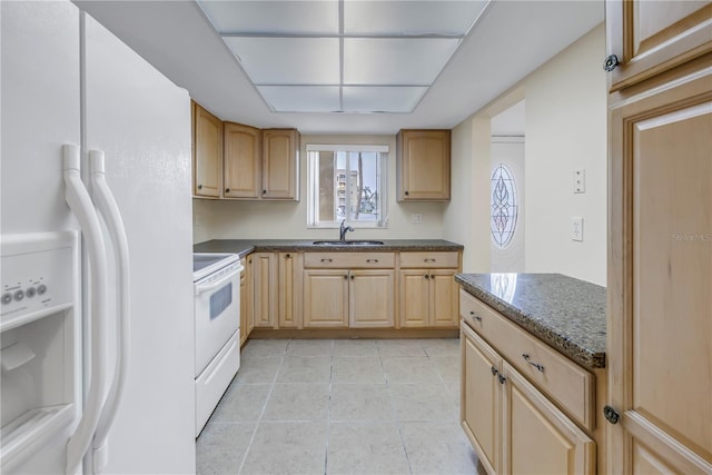 kitchen featuring white appliances, light brown cabinets, a sink, and light tile patterned flooring