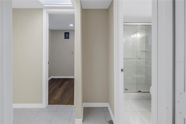 bathroom featuring a stall shower, tile patterned floors, and baseboards