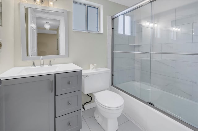 bathroom featuring toilet, shower / bath combination with glass door, and vanity