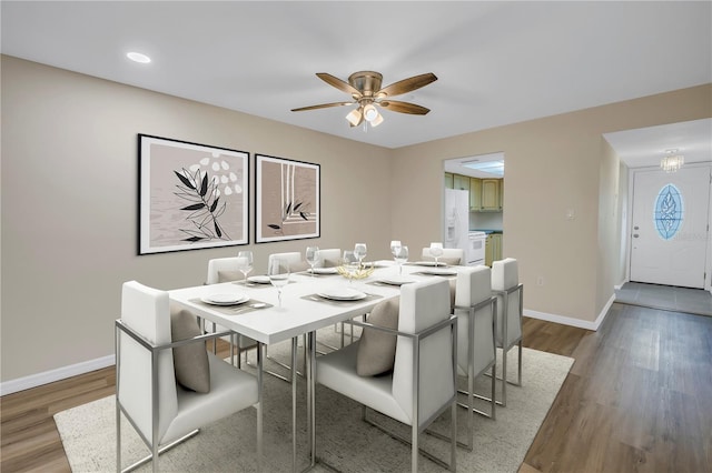 dining area featuring a ceiling fan, baseboards, wood finished floors, and recessed lighting